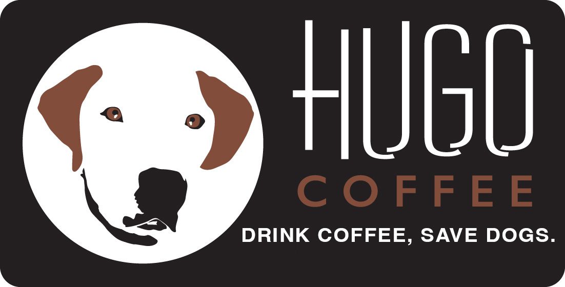 A dog is sitting in front of the huck coffee logo.