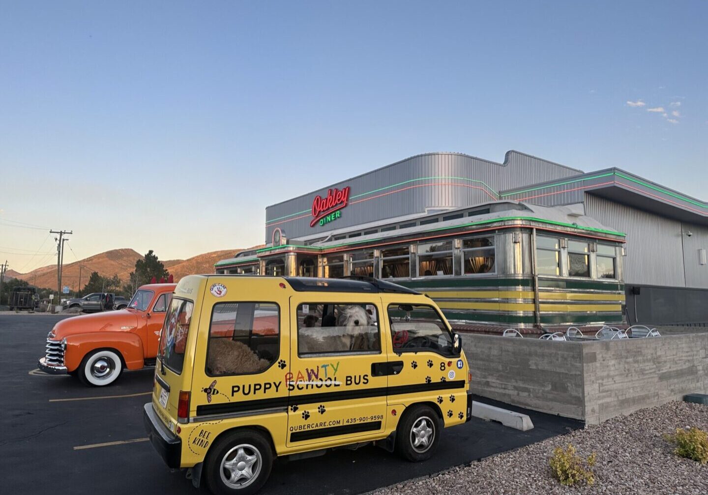 A yellow van parked in front of a drive-thru.